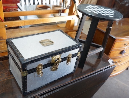 A circular marble topped games table, diameter 40cm, height 54cm, together with a small metal trunk